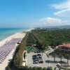 Spiaggia con ombrelloni e mare azzurro.